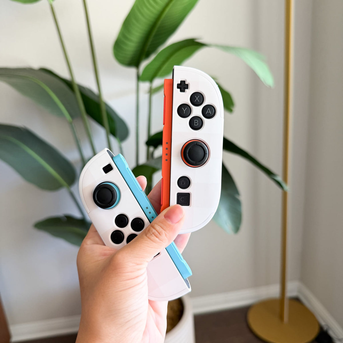 Beige Linen Switch 2 Joy-Con covers in hand
