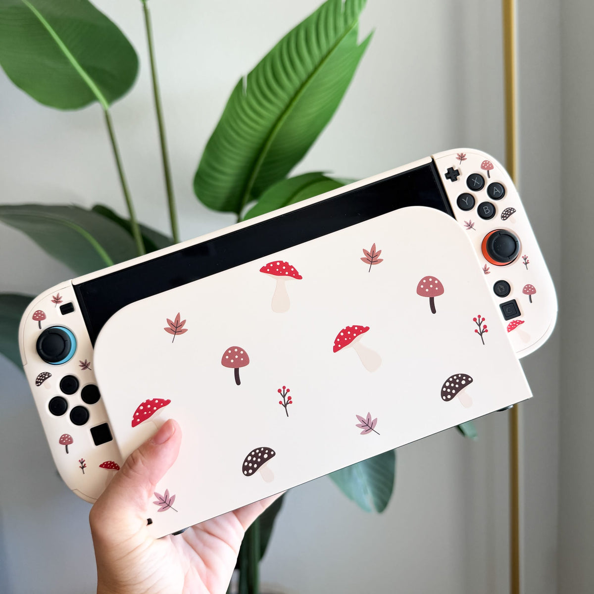 Autumn Mushies Switch 2 protective case, back view in hand